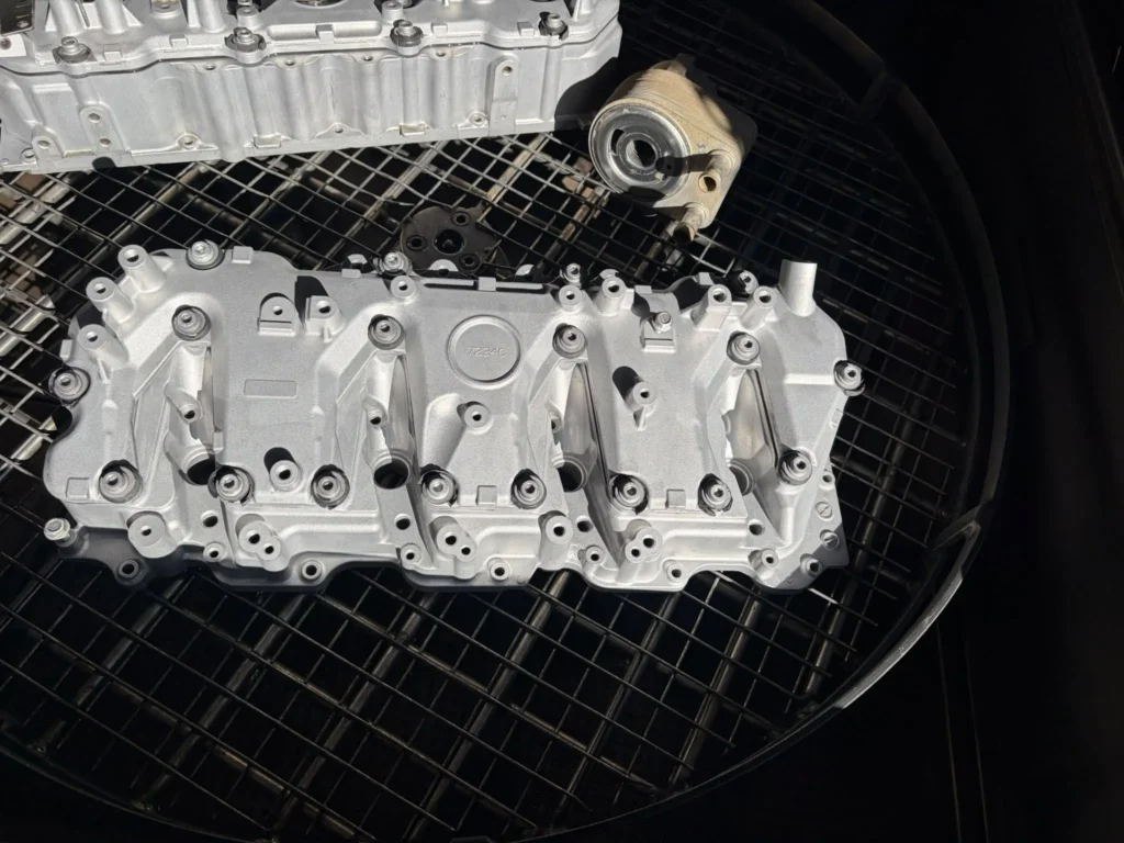 Duramax valve cover after vapour blasting, restored to a clean satin alloy finish