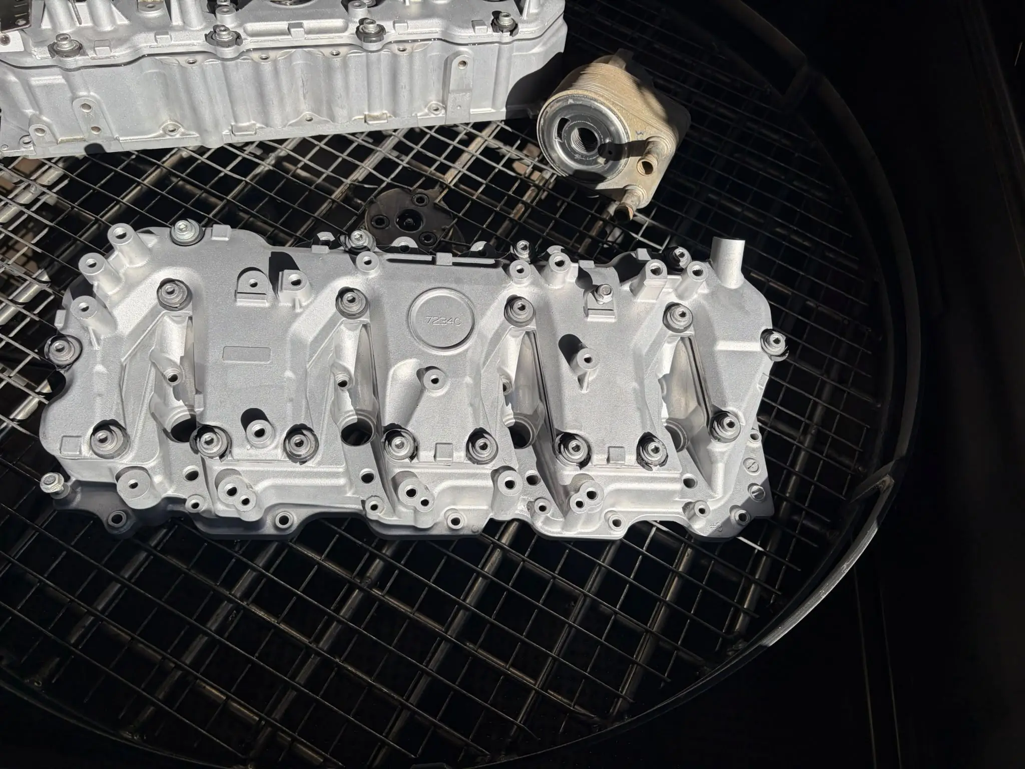 Duramax valve cover after vapour blasting, restored to a clean satin alloy finish